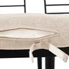 A close-up view of a beige cushion on a black frame, showing an open zipper and a velcro strap. Náhled obrázku produktu
