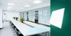 A meeting room with a long table and chairs, and a separate image of a white LED panel. Produktbild-Vorschau