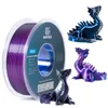 A spool of purple 3D printer filament is shown next to three 3D printed dragon figurines in blue, purple, and black. Produktbild-Vorschau