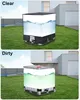 Two images showing an IBC container with a cover, one labeled 'Clear' and the other 'Dirty', placed in a yard next to a modern house. Produktbild-Vorschau