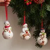 Three snowman ornaments hanging from a Christmas tree branch. Podgląd zdjęcia produktu