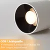 A close-up of a white cylindrical LED spotlight with a black interior, showing the illuminated COB light source. Text overlays describe the product's features. Produktbild-Vorschau