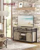 A living room scene featuring a TV stand with a television on it, a lamp, and a rug. Voir les images du produit