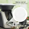 A kitchen appliance with a blender jar lid and some ingredients on a table. Náhled obrázku produktu