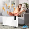 A woman and her dog are sitting on a couch next to a white electric heater, with orange arrows indicating heat flow. Voir les images du produit