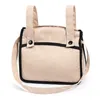 A beige and black bag with two handles and a shoulder strap, shown against a white background. Produktbild-Vorschau