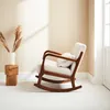 A rocking chair in a minimalist room with natural light. Produktbild-Vorschau