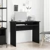 A black wooden desk with a computer and keyboard on it, in a room with a pegboard on the wall. Podgląd zdjęcia produktu