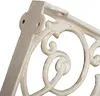 A close-up view of a white ornate cast iron shelf bracket. Náhľad obrázku produktu