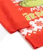 A close-up view of a red Christmas sweater with a Grinch design and snowflake patterns. Náhľad obrázku produktu