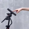 A hand is touching a phone holder mounted on an electric scooter. Voir les images du produit