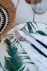 A close-up of a table setting with a plate, napkin, fork, and knife. Voir les images du produit