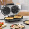 A close-up shot of a black waffle maker with two heart-shaped waffles being prepared. Produktbild-Vorschau
