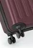 A close-up view of the wheels and bottom corner of a burgundy suitcase. Anteprima dell’immagine prodotto