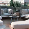 A modern outdoor living space with comfortable seating and a small coffee table. Podgląd zdjęcia produktu