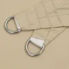 A close-up view of two reinforced corners of a beige sun sail, each with a D-ring for attachment. Anteprima dell’immagine prodotto