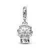 A silver charm shaped like a snow globe with snowflakes inside, hanging from a bail. Podgląd zdjęcia produktu