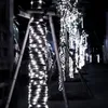 A street lined with trees decorated with white LED lights at night. Náhled obrázku produktu