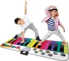 Two children are playing on a giant piano mat. Produktbild-Vorschau