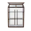 A wooden and polycarbonate mini greenhouse with double doors and shelves. Voir les images du produit