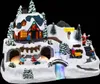 A festive Christmas village scene with a house, Santa, children playing in the snow, and a waterfall. Náhľad obrázku produktu