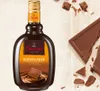 A bottle of Sarotti Schokoladenlikör is shown next to pieces of chocolate on a light-colored surface. Produktbild-Vorschau