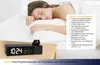 A woman sleeping in bed next to a digital alarm clock with a projection feature. Anteprima dell’immagine prodotto