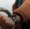 A person wearing a smartwatch while holding onto a bicycle handlebar. Náhled obrázku produktu