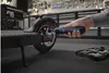 A person is using a Bosch cordless screwdriver to work on an electric scooter in a workshop. Voir les images du produit
