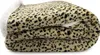 A folded leopard print blanket with a white sherpa trim. Produktbild-Vorschau