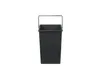 A dark gray trash can with a metal handle is shown against a white background. Produktbild-Vorschau