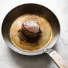 A steak is being seared in a pan. Anteprima dell’immagine prodotto