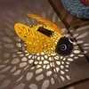 A solar-powered decorative bee lantern casting patterned light on a stone surface. Produktbild-Vorschau