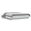 A white bed frame with a grey duvet and white sheets, shown from a side angle against a white background. Produktbild-Vorschau
