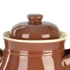 A close-up view of the lid and rim of a brown ceramic jar. Náhled obrázku produktu