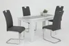 A dining table with four chairs set against a white background. Produktbild-Vorschau