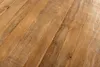 A close-up view of a wooden surface, showing the grain and texture of the wood. Produktbild-Vorschau