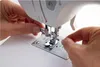 A close-up shot of hands threading a sewing machine needle. Produktbild-Vorschau