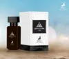 A perfume bottle and its box are displayed on a sandy surface with a blurred blue sky background. Podgląd zdjęcia produktu