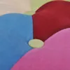 A close-up view of a colorful, tufted cushion or chair segment. Produktbild-Vorschau