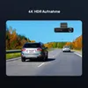 A dashcam is shown mounted on a car's windshield, capturing a road scene with other cars and autumn foliage. Produktbild-Vorschau