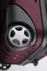 Close-up view of the wheel and bottom corner of a burgundy suitcase. Náhľad obrázku produktu