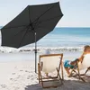 Two people relaxing on beach chairs under a large black umbrella. Voir les images du produit