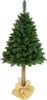 A green artificial Christmas tree with a brown trunk, standing on a tan burlap base, isolated on a white background. Náhľad obrázku produktu