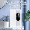 A white dehumidifier is placed on a countertop next to a sink and bathroom accessories, with text overlays describing its features. Produktbild-Vorschau