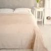 A neatly made bed with a beige striped blanket and white pillows. Anteprima dell’immagine prodotto