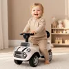 A baby is sitting on a toy car in a room. Náhled obrázku produktu