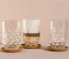 Three glasses on a pink background, one with a latte. Anteprima dell’immagine prodotto