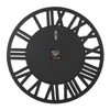 The back of a black wall clock with Roman numerals. Anteprima dell’immagine prodotto