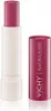 A pink tinted lip balm with its cap off, placed next to the cap. Voir les images du produit